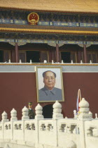 Policeman standing under a picture of Chairman Mao