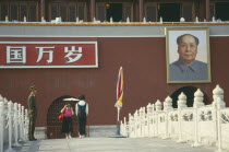 Policeman under picture of Chairman Mao