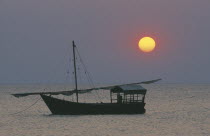 Sunset with dhow at anchor