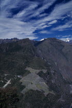 Aerial view over mountain landscape with hilltop Inca city ruins