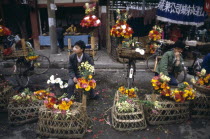 Vendors sitting with displays at the Flower Market