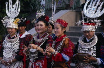 Miao girls in traditional festival costume with silver head-dresses Asia Asian Chinese Chungkuo Jhongguo Religion Zhonggu Classic Classical Historical Jhonggu Older Religious