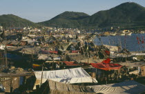 The harbour with fishing boats moored alongside each other