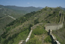 View along the crumbling wall leading over hills in to the distance