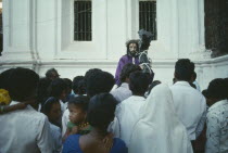 Easter procession with people looking toward the Statue of Christ  with face visible.