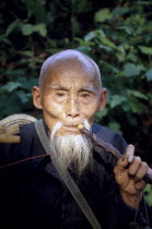Portrait of an old man smoking a pipe