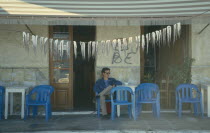 Squid hanging up to dry outside cafe/taverna.