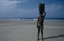 Young boy from Karnataka selling drinks on the beach