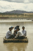 People traveling down river on Hide Raft