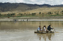 Hide raft with several people being rowed along the Yellow River