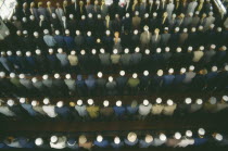 View looking down on rows of praying Muslims in a Mosque on festival day to mark the end of Ramadan.