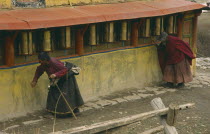 Tibetan pilgrims turning prayer wheels.