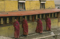 Monks turning prayer wheels at Zoige monastery