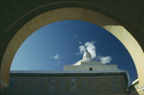 Mosque dome seen through arch