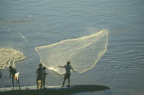 Fishermen casting net