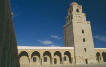 Mosque and courtyard with minaret behind