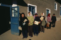 People affected by floods waiting in line at food distribution centre to be given WFP rice. Center