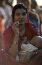 Young mother breastfeeding baby.