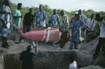 Burial of Ga tribal priestess of the sea god Kanjar in coffin made and painted to represent a mermaid following tradition of decorating coffin to reflect life of the deceased.