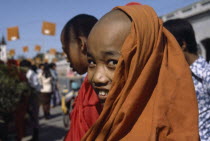 Young Buddhist monk smiling wearing orange robes Burma