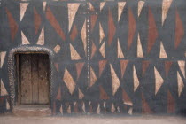 Traditional mud architecture.  Walls painted with broken calabash pattern in red  black and white  an expression of ever useful.  Raised doorway keeps out water.Sirigu village.  West Africa