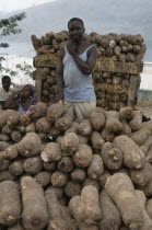 Man with yams for sale.West Africa