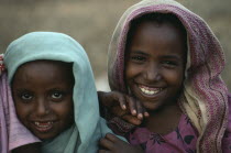 Head and shoulders portrait of two Ethiopian refugee girls.