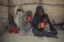 Women and malnourished children at Red Cross feeding centre. Center