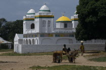 Village Mosque with a boy on a donkey and cart in the foreground