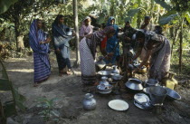 Women collecting water at hand pump.