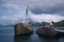 Abandoned whale catchers semi capsized in the water.