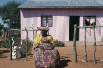 Herero lady in traditional dress sitting outside her home.African Namibian Southern Africa Classic Classical Historical Older History