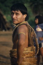 A Uru Eu Wau Wau Indian with lianas  vines wound round his waist and beaded jewellery. Brasil