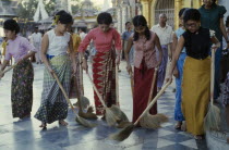 Schwedagon Pagoda.  Women sweeping black and white chequered floor of pagoda.Burma Rangoon