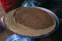 Deda camp for people displaced by war with Ethiopia.  Cooking injera a type of sour  flat bread that accompanies most meals.injira  refugee  IDP