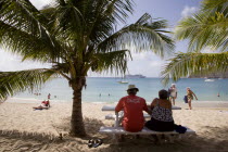 Tourists on beach at Lower Bay with cruise ship offshore