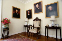 Interior of the Jacobean plantation house of St Nicholas Abbey showing oil paintings of past owners