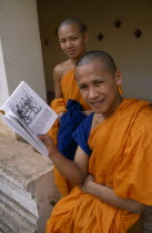 Young Buddhist monks with book.