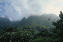 Sorak Mountains.  Cable car to peak of Chipsonbong mountain wreathed in cloud with lush vegetation below. Automobile