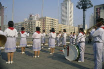 Juche ideology.  Band playing outside the railway station to encourage workers and travellers.