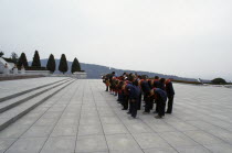 Group of children paying their respects at the Tomb of the Martyrs outside the city.