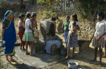 Women and girls gathered at a water outlet