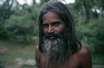 Portrait of man with beard and long hair standing within green landscape.brahmane de kanniyai  brahmane de kanniyai