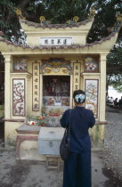 Woman praying at a shrine