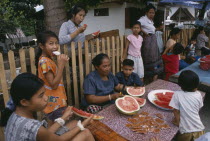 Family group eating watermelon