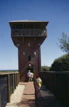 Visitors on walkway leading to whale watch tower.