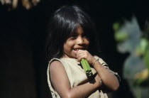 Portrait of young Kogi Indian child chewing green canes