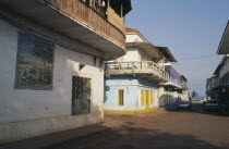 Quiet street in the commercial area with mural painted on exterior wall of building in foreground.