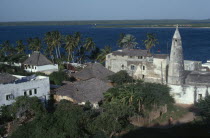 Town rooftops and sea beyond.