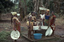 Women collecting water from well standpipe. Igbo